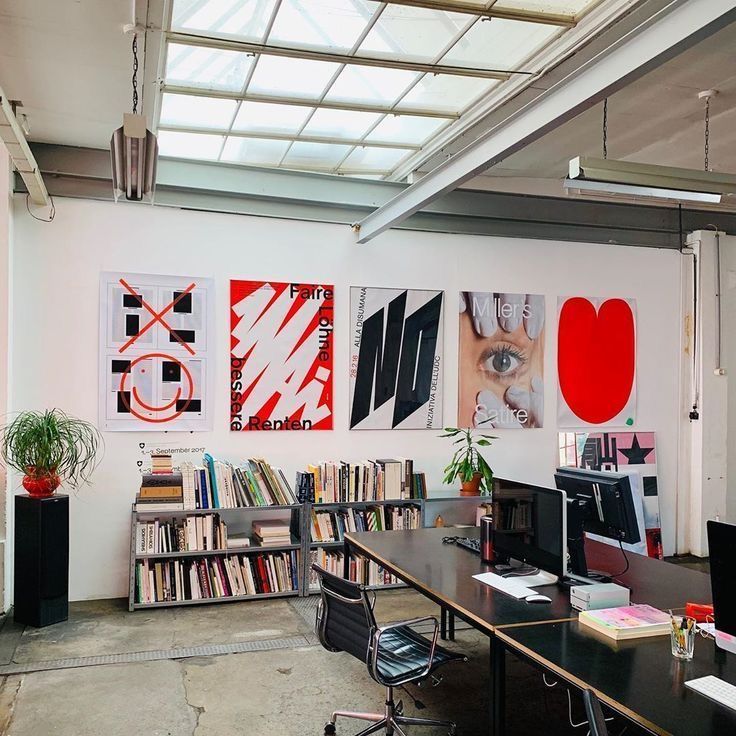 Bold red, black, and white brand poster wall in the Ironclad Strategy studio
