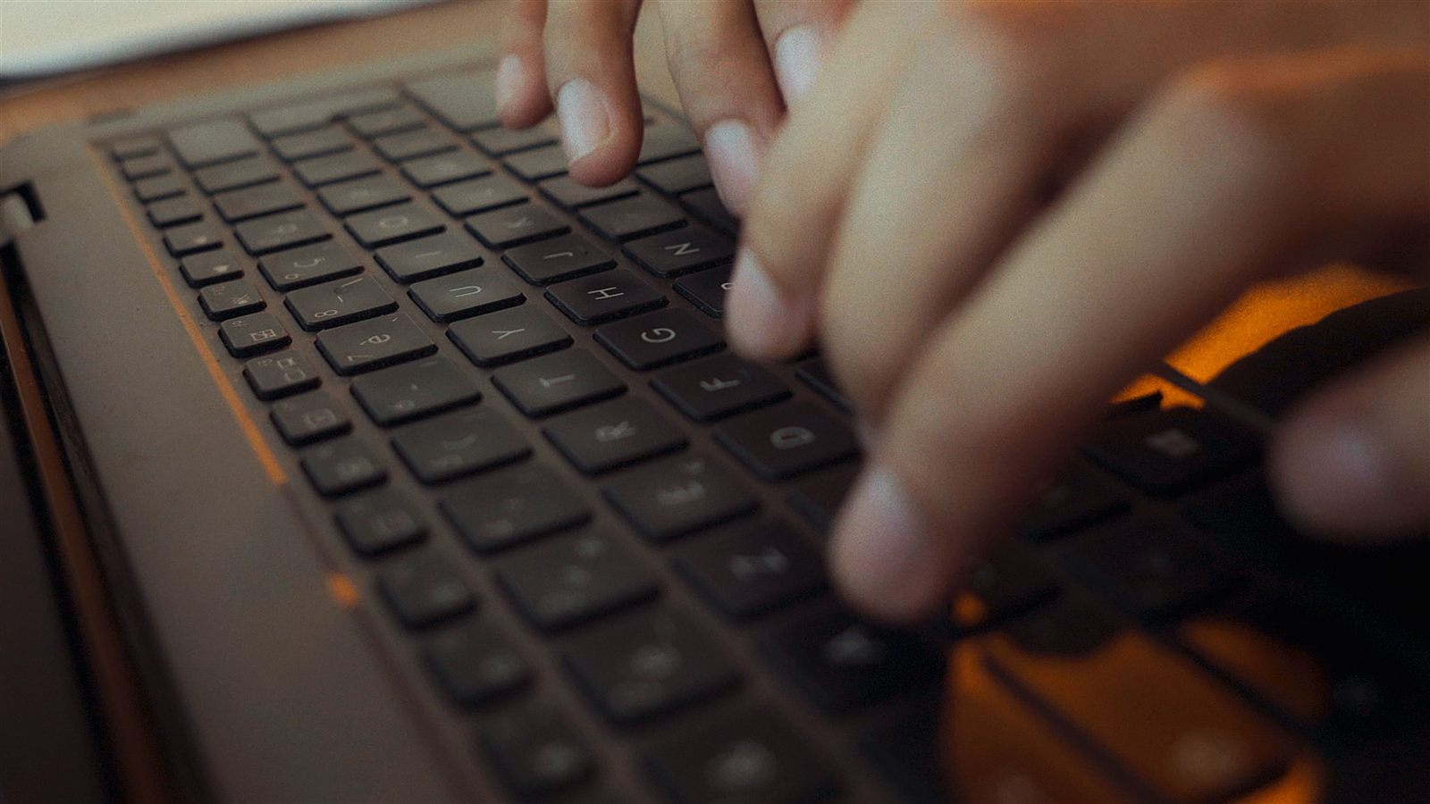 Close-up of hands typing on a laptop during the NEXORA SaaS narrative rebuild